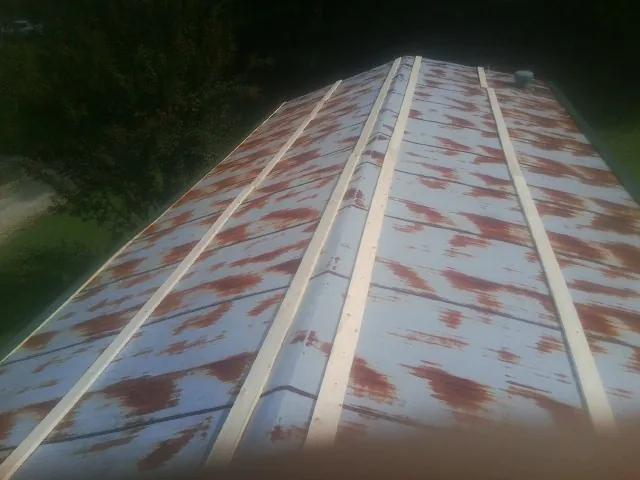 Rusted metal roof panels with new wood purlins before replacement — Storm Damage Roof Repair in La Palma by Roofing Brothers