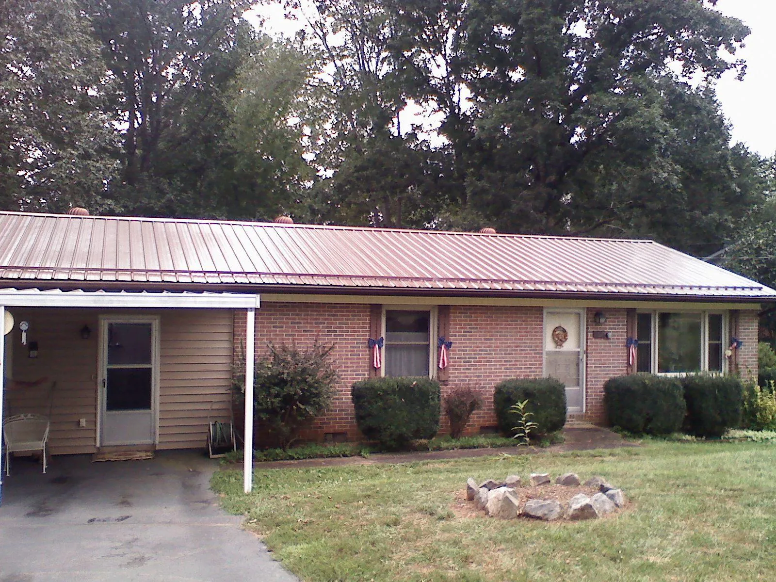 Bronze metal roof and carport on a brick ranch home — Roof Repair work by our crew in La Palma